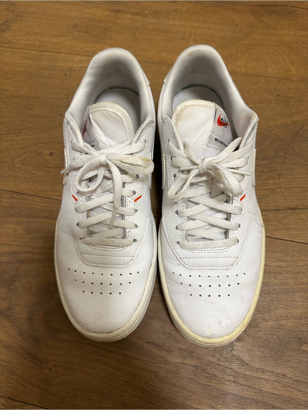 Nike Women's White Sneakers with Small Orange Swoosh Accent